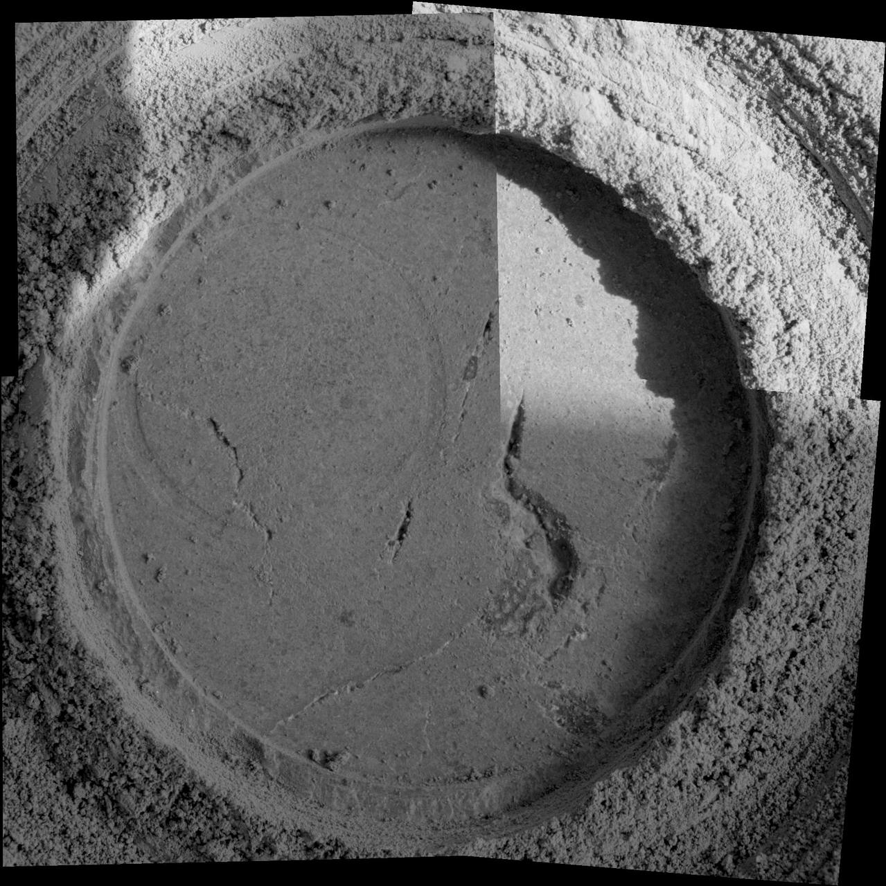 Close-up examination of a freshly exposed area of a rock called "Uchben" in the "Columbia Hills" of Mars reveals an assortment of particle shapes and sizes in the rock's makeup. NASA's Mars Exploration Rover Spirit used its microscopic imager during the rover's 286th martian day (Oct. 22, 2004) to take the frames assembled into this view. The view covers a circular hole ground into a target spot called "Koolik" on Uchben by the rover's rock abrasion tool. The circle is 4.5 centimeters (1.8 inches) in diameter. Particles in the rock vary in shape from angular to round, and range in size from about 0.5 millimeter (0.2 inch) to too small to be seen. This assortment suggests that the rock originated from particles that had not been transported much by wind or water, because such a transport process would likely have resulted in more sorting of the particles by size and shape.   http://photojournal.jpl.nasa.gov/catalog/PIA07023