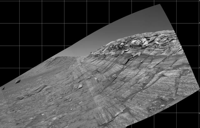 NASA's Mars Exploration Rover Opportunity captured this view from the base of "Burns Cliff" during the rover's 280th martian day (Nov. 6, 2004). This cliff in the inner wall of "Endurance Crater" displays multiple layers of bedrock for the rover to examine with its panoramic camera and miniature thermal emission spectrometer. The rover team has decided that the farthest Opportunity can safely advance along the base of the cliff is close to the squarish white rock near the center of this image. After examining the site for a few days from that position, the the rover will turn around and head out of the crater. The view is a mosaic of frames taken by Opportunity's navigation camera. The rover was on ground with a slope of about 30 degrees when the pictures were taken, and the view is presented here in a way that corrects for that tilt of the camera. http://photojournal.jpl.nasa.gov/catalog/PIA07039