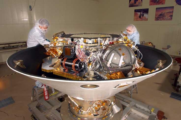 The Phoenix lander, housed in a 100,000-class clean room at Lockheed Martin Space Systems facilities near Denver, Colo. Shown here, the lander is contained inside the backshell portion of the aeroshell with the heat shield removed.