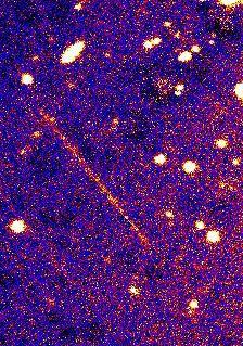 The high speed of NASA Deep Impact spacecraft causes it to appear as a long streak across the sky in the constellation Virgo during the 10-minute exposure time of this photograph taken by Mr. Palomar 200-inch telescope.