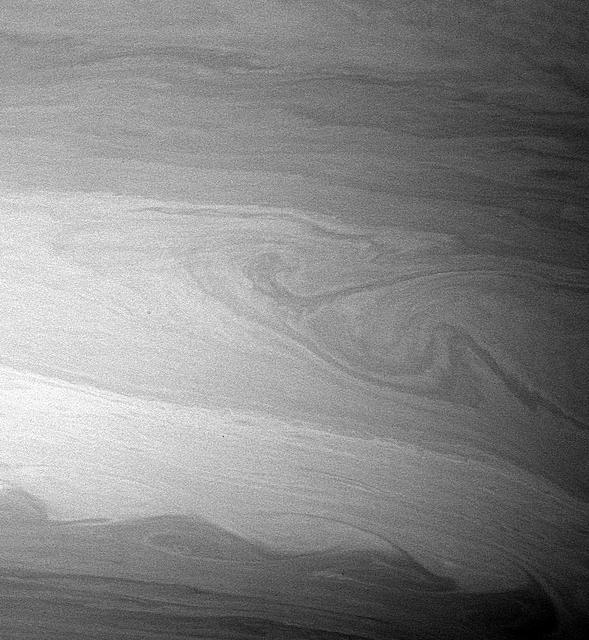 During its time in orbit, Cassini has spotted many beautiful cat's eye-shaped patterns like the ones visible here. These patterns occur in places where the winds and the atmospheric density at one latitude are different from those at another latitude. The opposing east-west flowing cloud bands are the dominant patterns seen here and elsewhere in Saturn's atmosphere. Contrast in the image was enhanced to aid the visibility of atmospheric features. The image was taken with the Cassini spacecraft wide-angle camera on Aug. 20, 2005. http://photojournal.jpl.nasa.gov/catalog/PIA07600