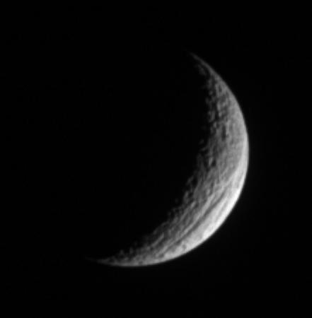 A crescent Tethys shows off its great scar, Ithaca Chasma, for which the  moon is renowned. The chasm is 100 kilometers 60 miles across on  average, and is 4 kilometers 2 miles deep in places.