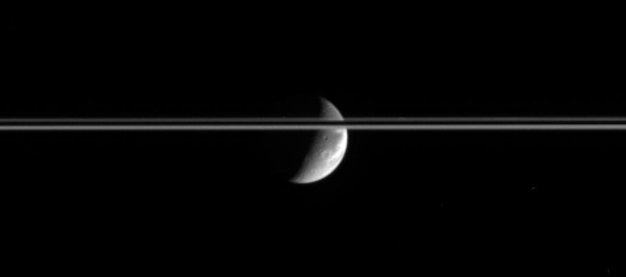After journeying a bit more than an hour across the Solar System, bright sunlight reflects off the gleaming icy cliffs in the wispy terrain of  Dione and is captured by NASA Cassini spacecraft cameras several light  seconds later