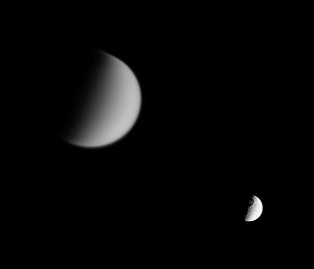 Cassini looks toward Tethys and its great crater Odysseus, while at the same time capturing veiled Titan in the distance at left