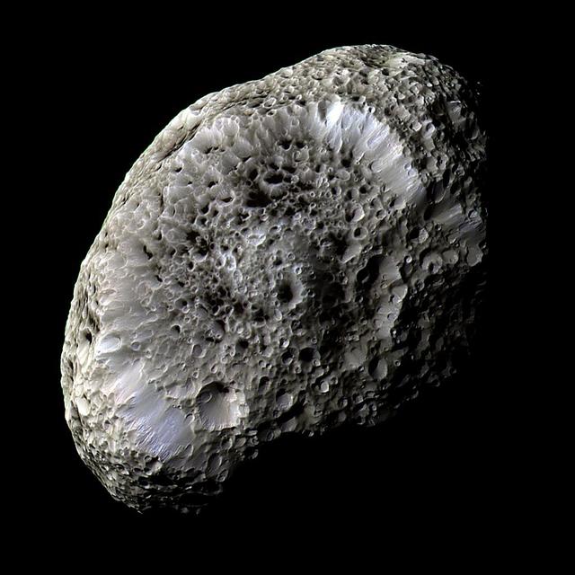 This stunning false-color view of Saturn moon Hyperion reveals crisp details across the strange, tumbling moon surface. The view was obtained during NASA Cassini close flyby on Sept. 26, 2005.