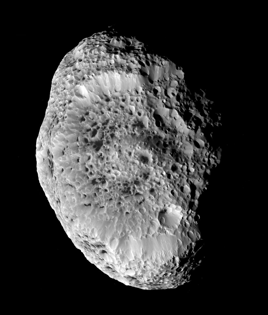 Saturn's impact-pummeled Hyperion stares back at Cassini in this six-image mosaic taken during the spacecraft’s close approach on Sept. 26, 2005. This up-close view shows a low density body blasted by impacts over the eons. Scientists originally believed that the spongy appearance of Hyperion is caused by a phenomenon called thermal erosion, in which dark materials accumulating on crater floors are warmed by sunlight and melt deeper into the surface, allowing surrounding ice to vaporize away. Cassini scientists now think that Hyperion’s unusual appearance can be attributed to the fact that it has an unusually low density for such a large object, giving it weak surface gravity and high porosity. These characteristics help preserve the original shapes of Hyperion’s craters by limiting the amount of impact ejecta coating the moon’s surface. Impactors tend to make craters by compressing the surface material, rather than blasting it out. Further, Hyperion’s weak gravity, and correspondingly low escape velocity, means that what little ejecta is produced has a good chance of escaping the moon altogether. At 280 kilometers, (174 miles) across, Hyperion’s impact-shaped morphology makes it the largest of Saturn's irregularly-shaped moons. Six, clear-filter images were combined to create this mosaic. Images were taken by the Cassini spacecraft narrow-angle camera at a mean distance of about 33,000 kilometers (20,500 miles) from Hyperion and at a sun-Hyperion-spacecraft, or phase, angle of 51 degrees. Image scale is 197 meters per pixel. http://photojournal.jpl.nasa.gov/catalog/PIA07761