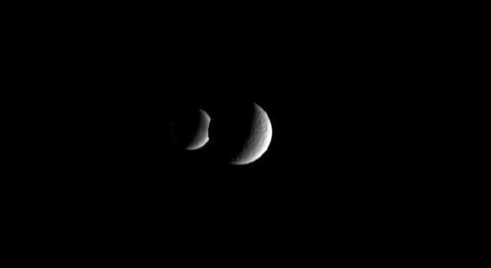 This animation show two crescent moons dance around Saturn as far-off Dione slips behind its  sibling moon Rhea