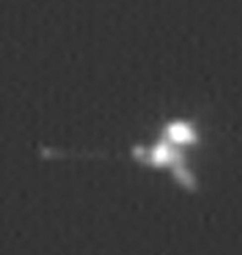 This view is an enlargement of an image of NASA Mars Odyssey spacecraft taken by the Mars Orbiter Camera aboard NASA Mars Global Surveyor while the two spacecraft were about 90 kilometers 56 miles apart.