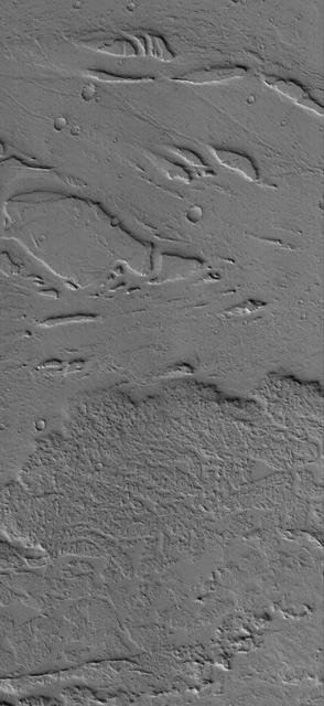 This image shows the margin of a lava flow on a plain northwest of Jovis Tholus, a volcanic construct located in the Tharsis region of Mars