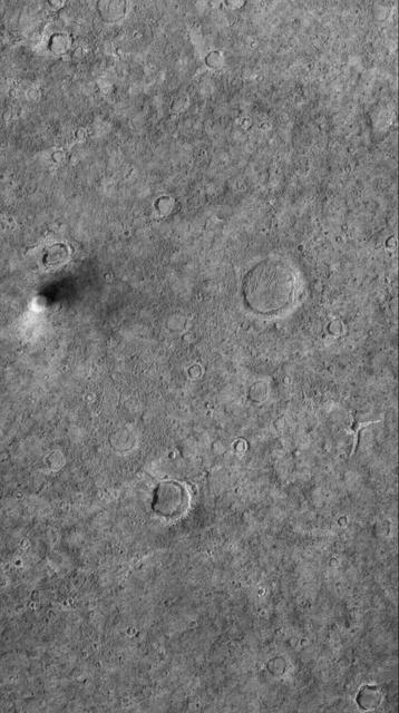 This MOC image shows a dust devil traveling across a plain west-southwest of Schiaparelli Crater, in far eastern Sinus Meridiani. The dust devil is casting a shadow toward the northeast, just south below of an egg-shaped crater