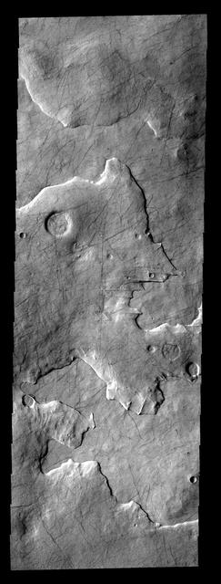 This layered region is between Aonia Planum and the south pole. The edges of the top layer have a moothed appearance that may be due to ice melting.