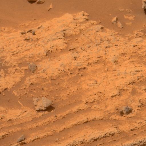 This view of layers around the edge of a low plateau called Home Plate inside Mars Gusev Crater includes a feature that may be what geologists call a bomb sag and interpret as evidence of an explosive event, such as a volcanic eruption