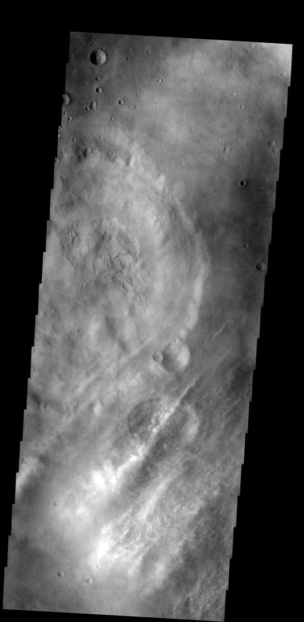 These streamers of clouds cross over a small crater without deflection