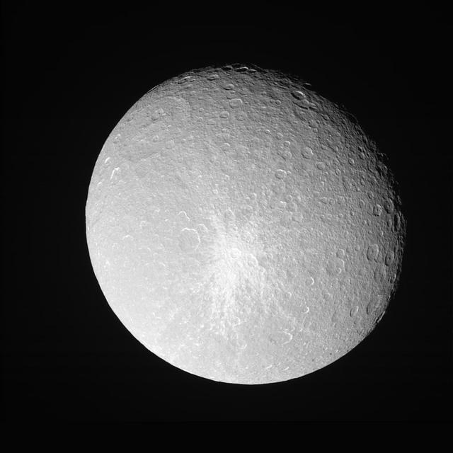 Rhea shows off her bright, fresh-looking impact crater in this Cassini  view taken during a close approach