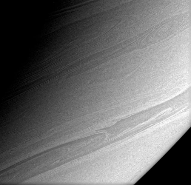 Long, thin streamers of cloud arc gracefully across this view of Saturn  southerly latitudes