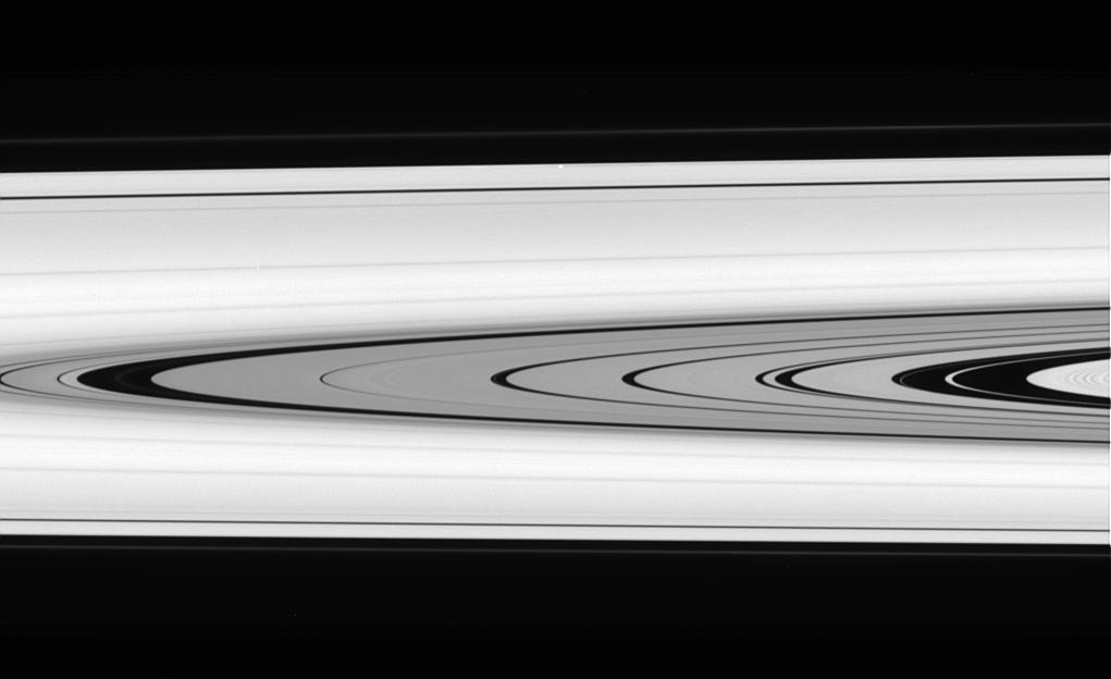 This splendid view offers a detailed look at the faint rings within the  Cassini Division as well as a rare glimpse of the Keeler gap moon,  Daphnis. The small, ring embedded moon is a bright unresolved speck above  center, near outer edge of A ring