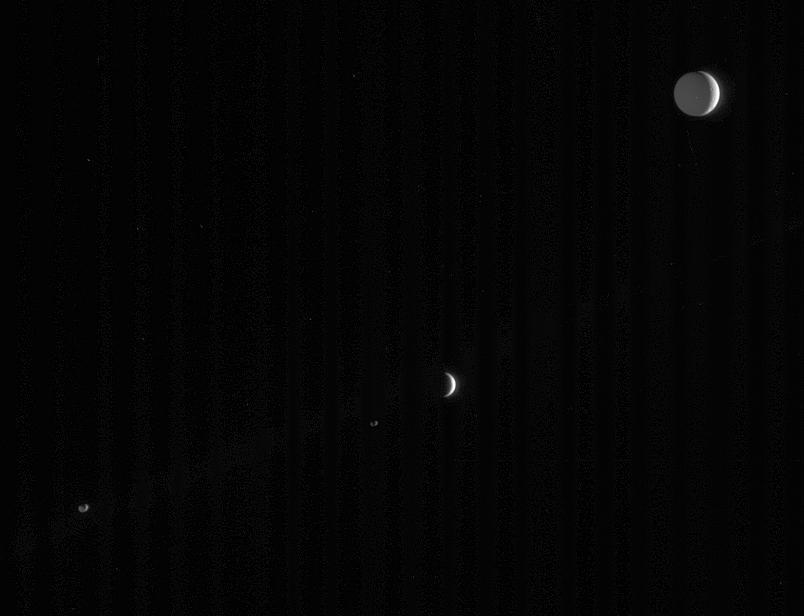 Four of Saturn many and varied moons crowd this single frame from  Cassini