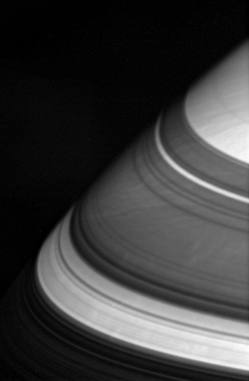 The dark shadows that drape Saturn northern latitudes are split by three  familiar bright gaps