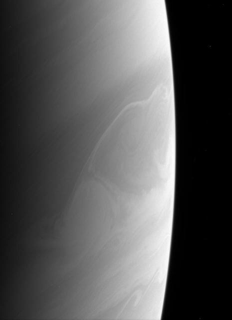 Saturn atmosphere produces beautiful and sometimes perplexing features. Is the bright feature below center a rare crossing of a feature from a zone to a belt, or is it an illusion created by different cloud layers at different levels?