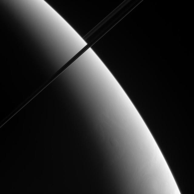 This oblique view of Saturn shows what may be localized upwellings in the clouds of Saturn southern hemisphere. Although the contrast is low, a vortex is visible near lower right.This view looks toward the unlit side of the rings