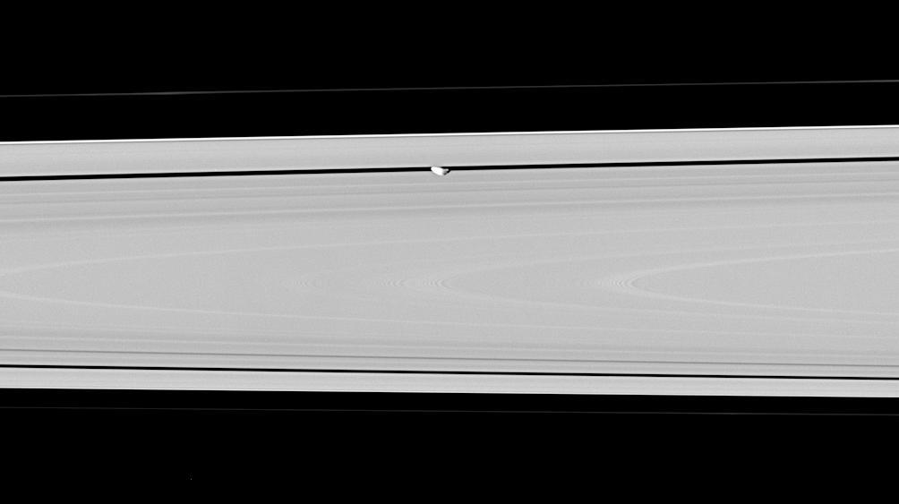 Hiding within the Encke gap is the small moon Pan, partly in shadow and party cut off by the outer A ring in this view. Similar to Atlas, Pan appears to have a slight ridge around its middle; and like Atlas, Pan orbit also coincides with a faint ringlet