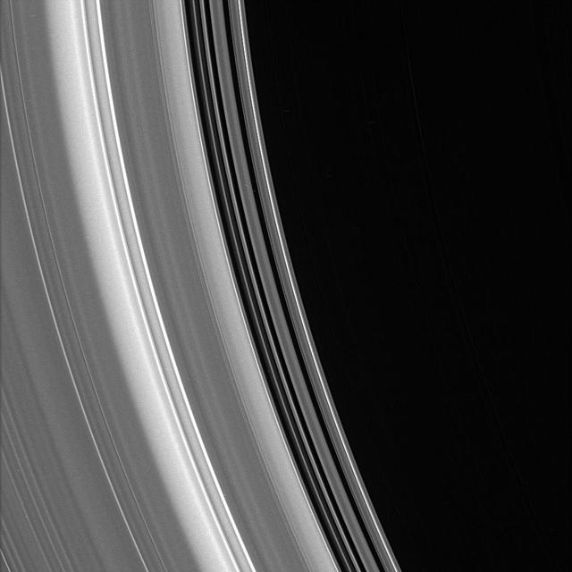 Bright ringlets and dark gaps at the inner edge of the C ring sweep across this scene. The C ring contains numerous plateaus -- broad ring regions that are bright and surrounded by fainter material