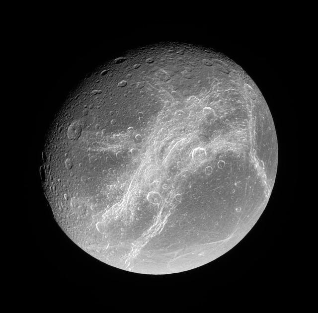 This splendid view showcases Dione tortured complex of bright cliffs. At lower right is the feature called Cassandra, exhibiting linear rays extending in multiple directions