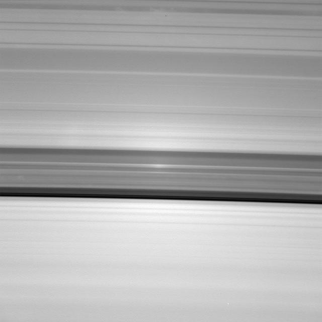 A brilliant spot of sunlight, the opposition effect, travels outward across the rings as the Cassini spacecraft orbits Saturn. This surge in ring brightness is created around the point directly opposite the Sun from the spacecraft