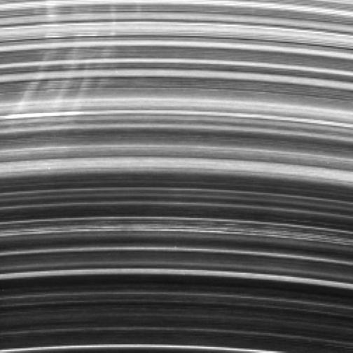 A group of bright spokes tightly cluster together in Saturn B ring. The  spokes seen here generally all exhibit the same degree of shearing, or  tilting, but some deviations are apparent