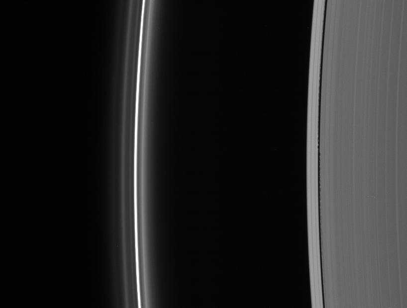 Edge waves in the Keeler Gap betray the presence of the embedded moon Daphnis. At left lies the brilliant F ring with its flanking strands