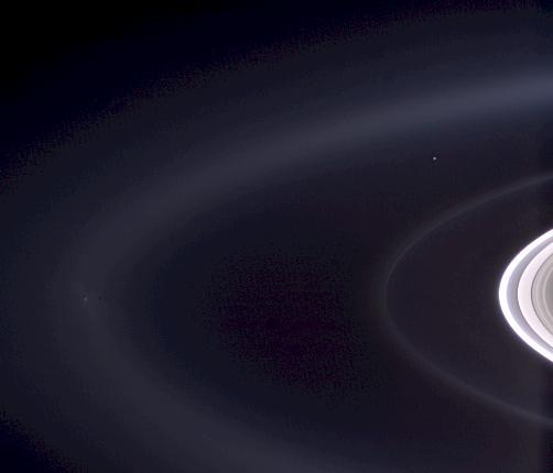 Cassini casts powerful eyes on our home planet, and captures Earth, a pale blue orb -- and a faint suggestion of our moon -- among the glories of the Saturn system.