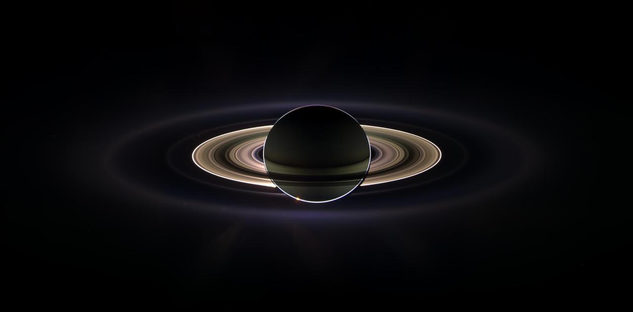 With giant Saturn hanging in the blackness and sheltering Cassini from the sun blinding glare, the spacecraft viewed the rings as never before, revealing previously unknown faint rings and even glimpsing its home world.