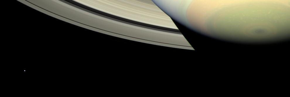Cassini takes in a sweeping view of Saturn south polar region as the planet shadow masks the rings and bright, icy Mimas looks on from left