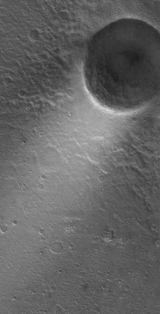 This MOC image shows a wind streak created in the lee -- the downwind side -- of a crater in far eastern Chryse Planitia. The winds responsible for the formation of the streak blew from the upper right northeast to the lower left southwest