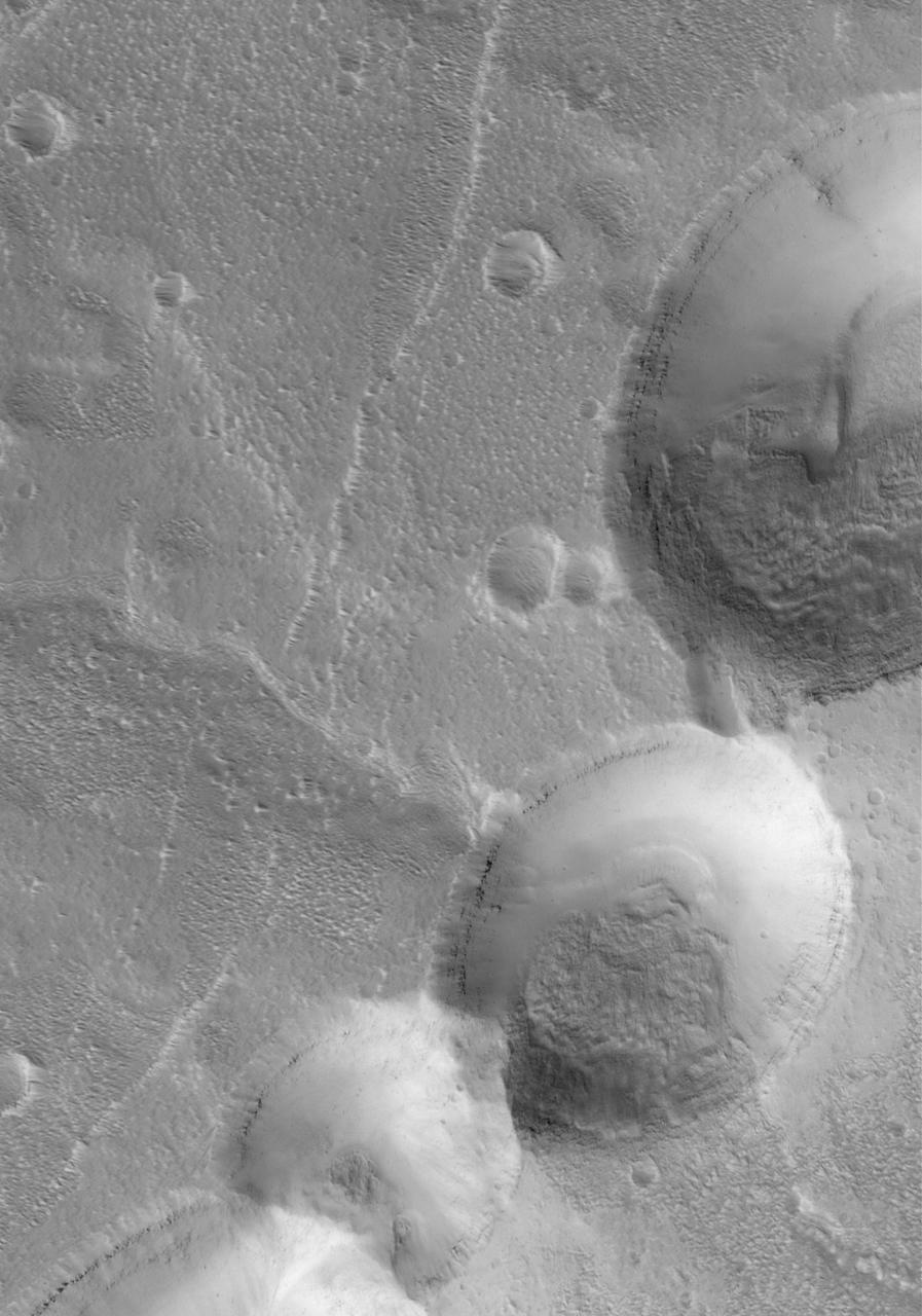 This MOC image shows partially-filled collapse pits on the eastern flank of Alba Patera, a large volcano in northern Tharsis