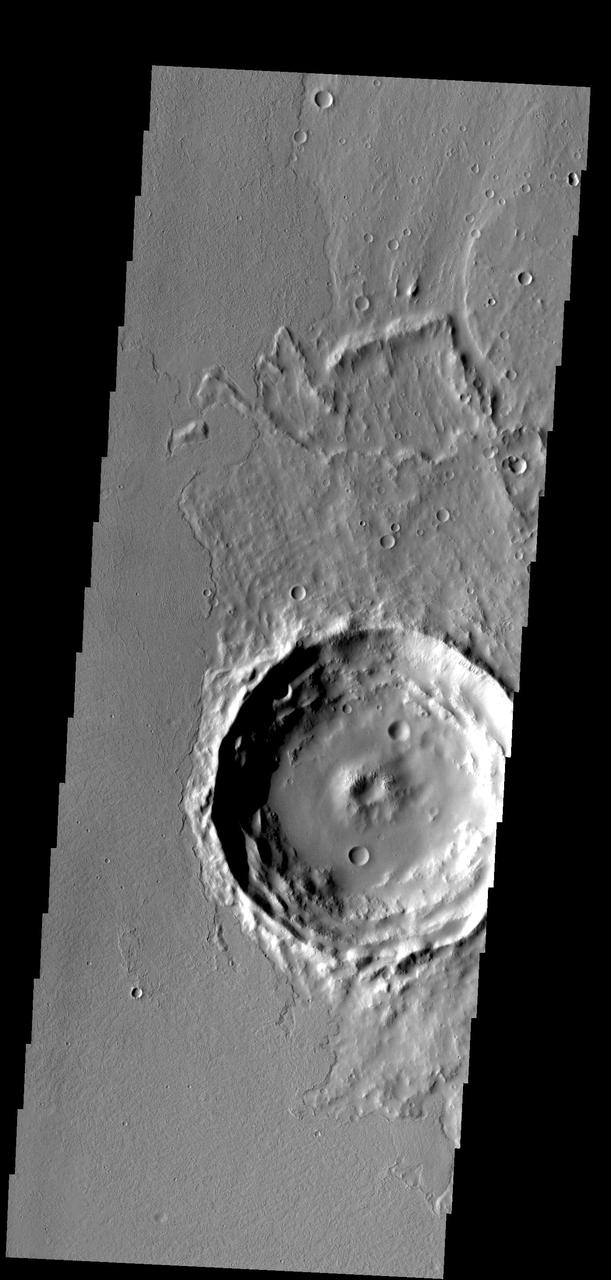 Located on the eastern edge of the Tharsis region, this crater has had  half of its ejecta covered by lava flows