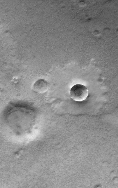 This MOC image shows a  pedestal crater superposed on the floor of the much larger Mellish Crater. When an impact crater of this type forms, material is thrown onto the  adjacent terrain to form portions of the ejecta blanket