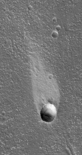 This MOC image shows a light-toned wind streak created in the -- the downwind side -- of an impact crater in the Cyane Fossae region of Mars