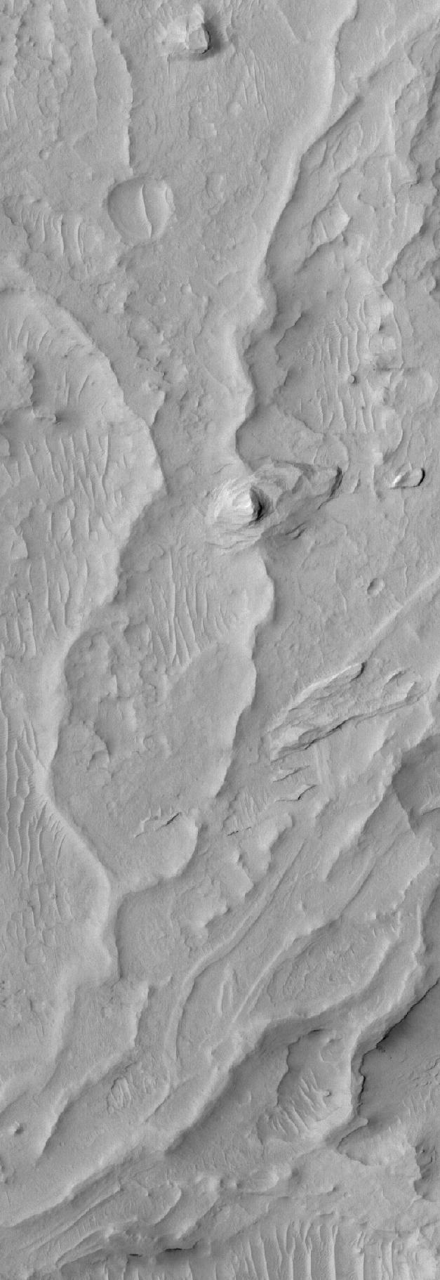 This MOC image shows sinuous ridges and other landforms exposed by erosion in the Aeolis region of Mars
