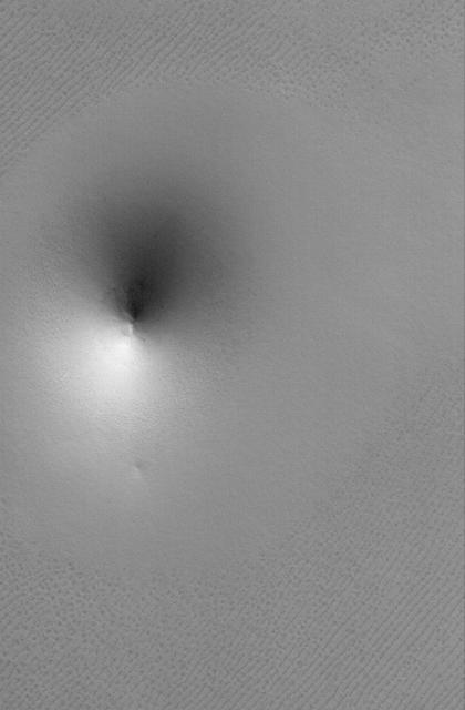 This MOC image shows a cone-shaped hill, perhaps a remnant of a material that was once more laterally extensive across the area, on a textured plain in the Hyperboreus Labyrinthus region in the north polar region of Mars