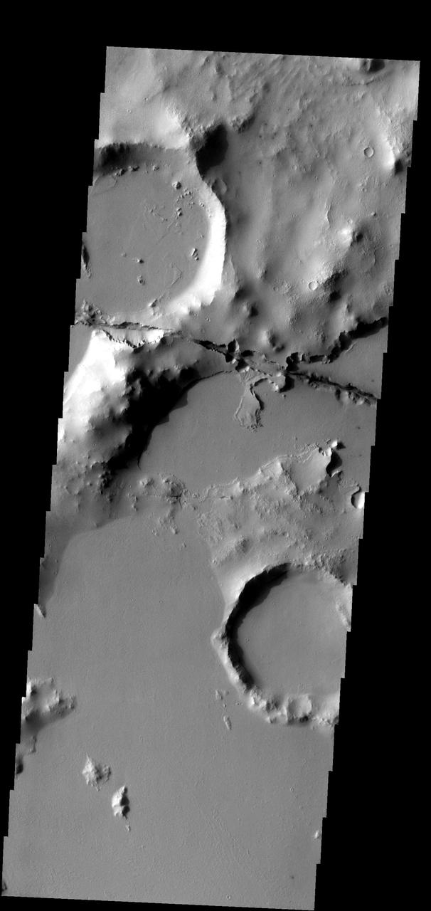 One of the Cerberus Fossae fractures cuts through the plains and highlands in this image