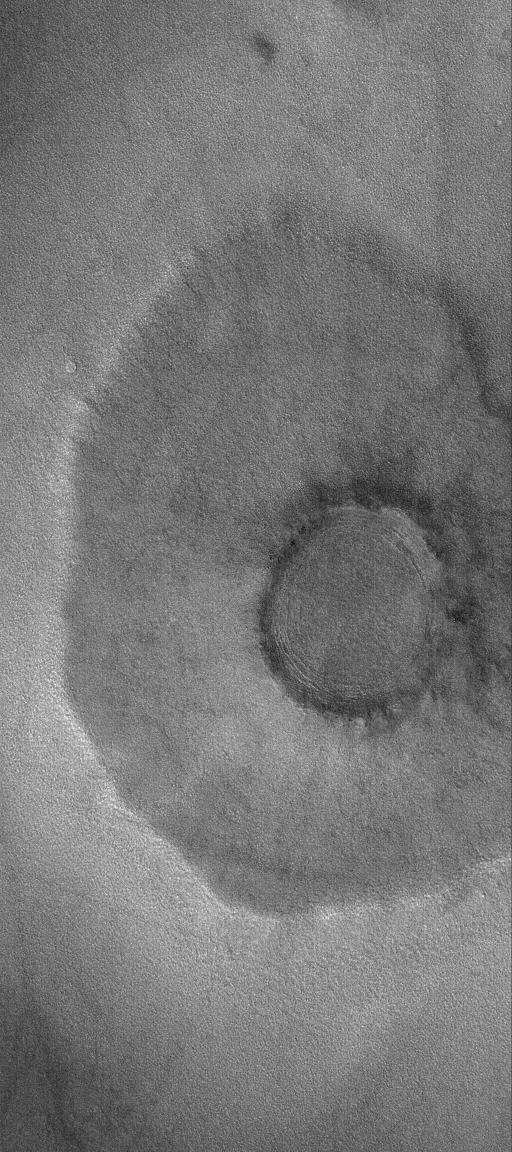 This MOC image shows a pedestal a pancake or pedestal crater on the martian northern plains. The rocky ejecta from the crater protected the underlying material from being stripped away by wind, leaving ejecta standing higher than surrounding terrain