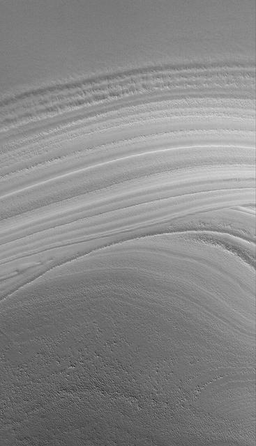 This MOC image shows an unconformity in a sequence of layered material in the martian north polar region created by erosion