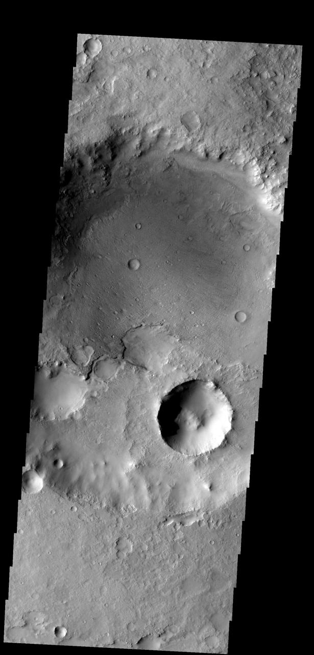 This crater, on the northern margin of Syrtis Major, has been filled with material that is now being removed