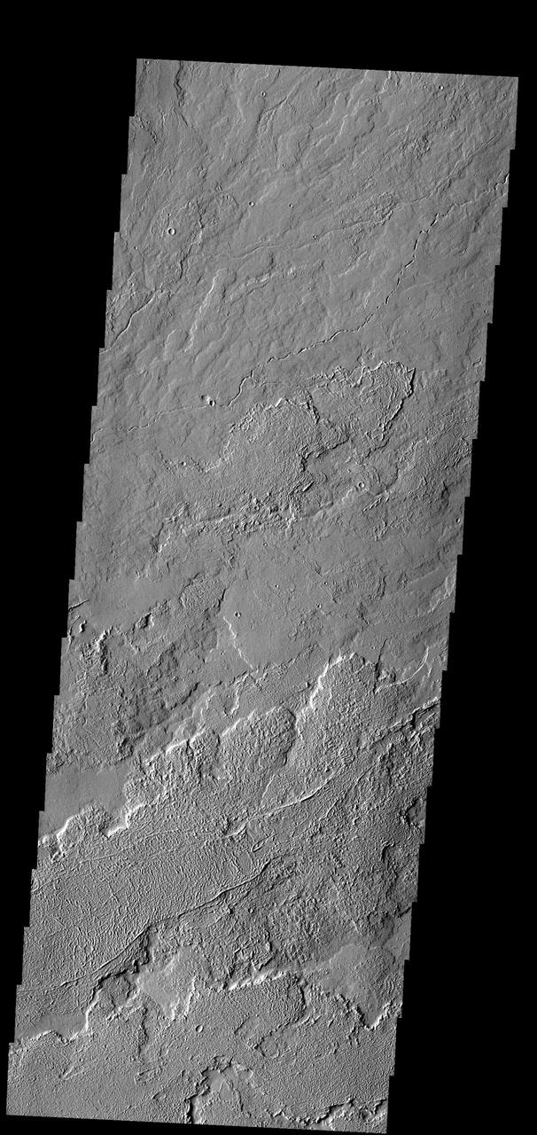 This image shows a small portion of the extensive Tharsis Volcanic Field. Several different surface textures are present in this image