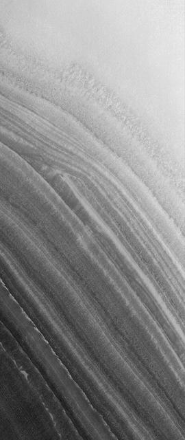This MOC image shows layered material exposed on a slope in the north polar region. An unconformity is visible in the middle/upper left of the image, where layers are abruptly truncated
