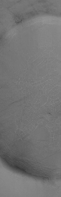 This MOC image shows cracks formed in the material that nearly fills an impact crater on the martian northern plains