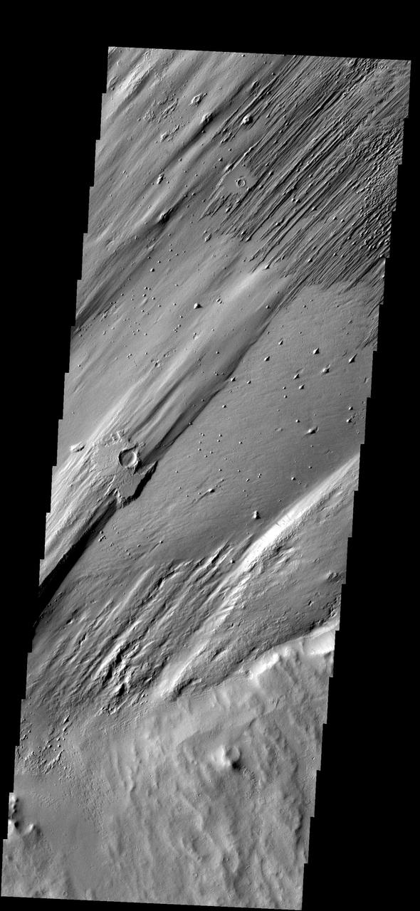 Only a portion of the ejecta remains around this crater. Wind action is creating yardangs and stripping off the surface materials in this region. The margin of Apollinaris Patera is at the bottom 1/3 of the frame