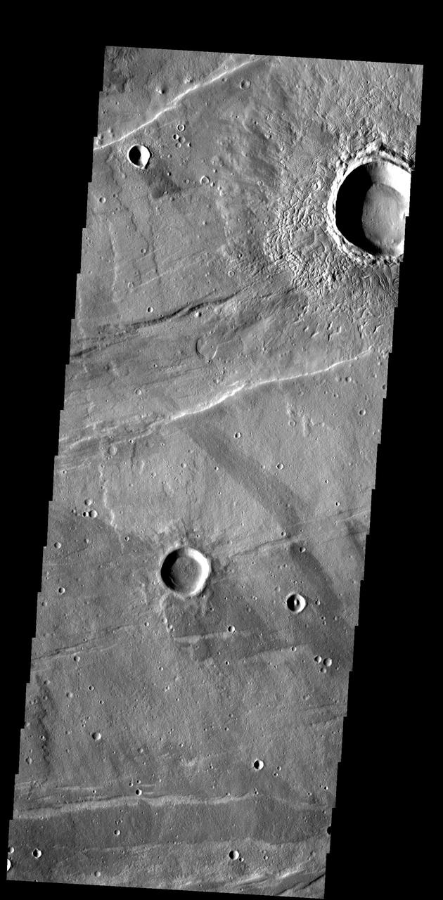 The ejecta surrounding this crater in Tempe Terra has an unusual texture that appears to contain small channels and fractures