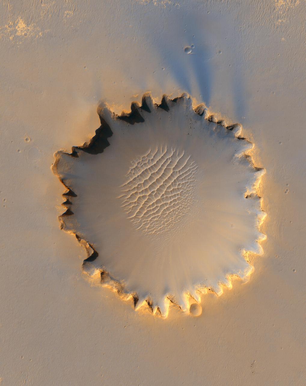 This image from the HiRISE instrument on NASA Mars Reconnaissance Orbiter shows Victoria crater, an impact crater at Meridiani Planum, near the equator of Mars.